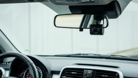 Compact dash cam mounted on small car windshield